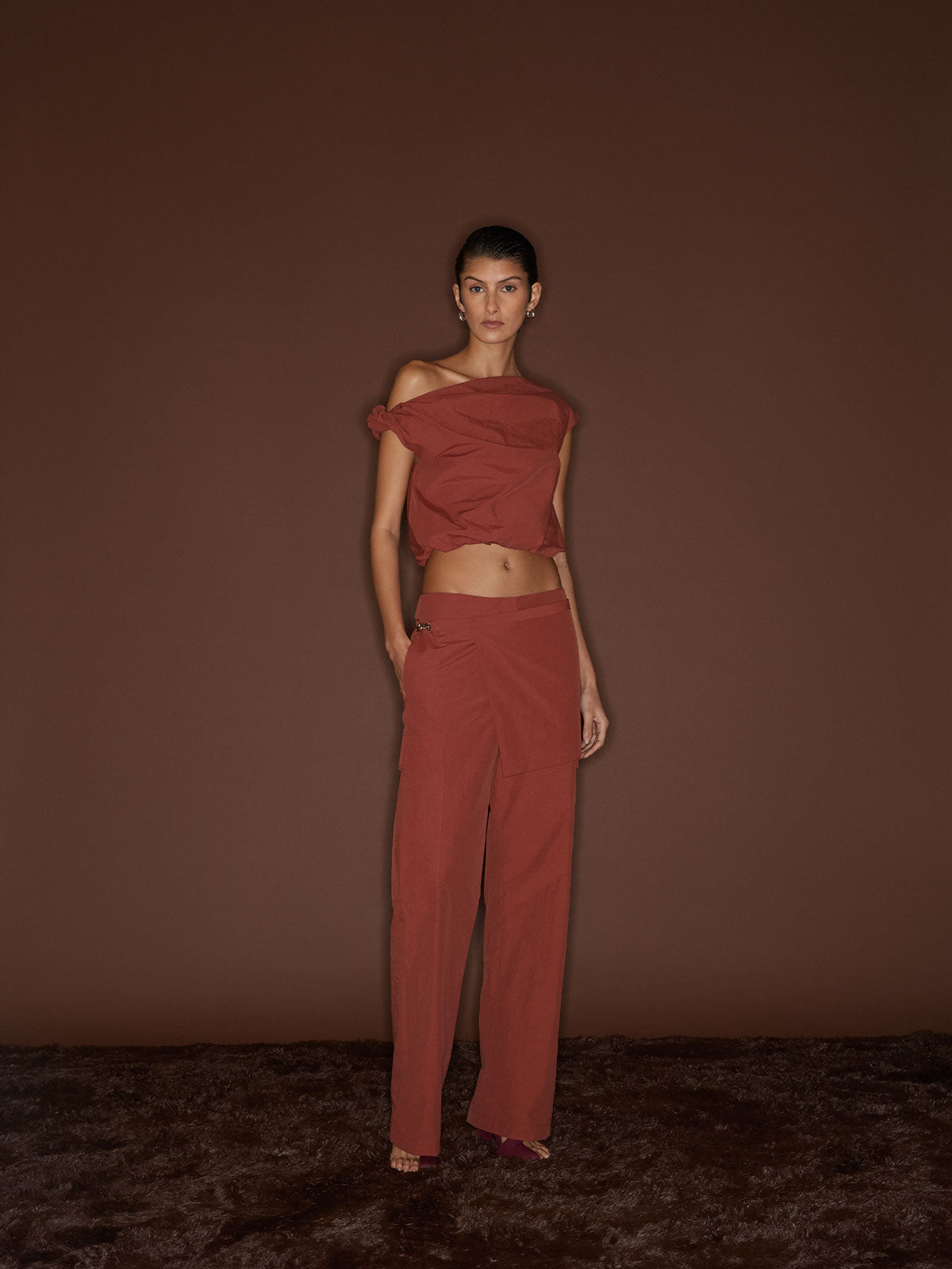 A female figure wearing the Spice 09 Alice Top and pants against a dark brown background