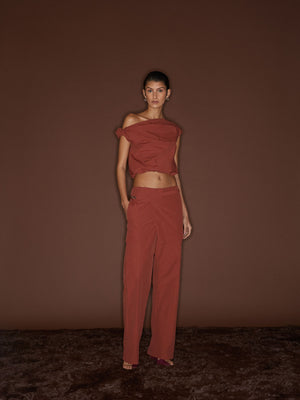 A female figure wearing the Spice 09 Alice Top and pants against a dark brown background