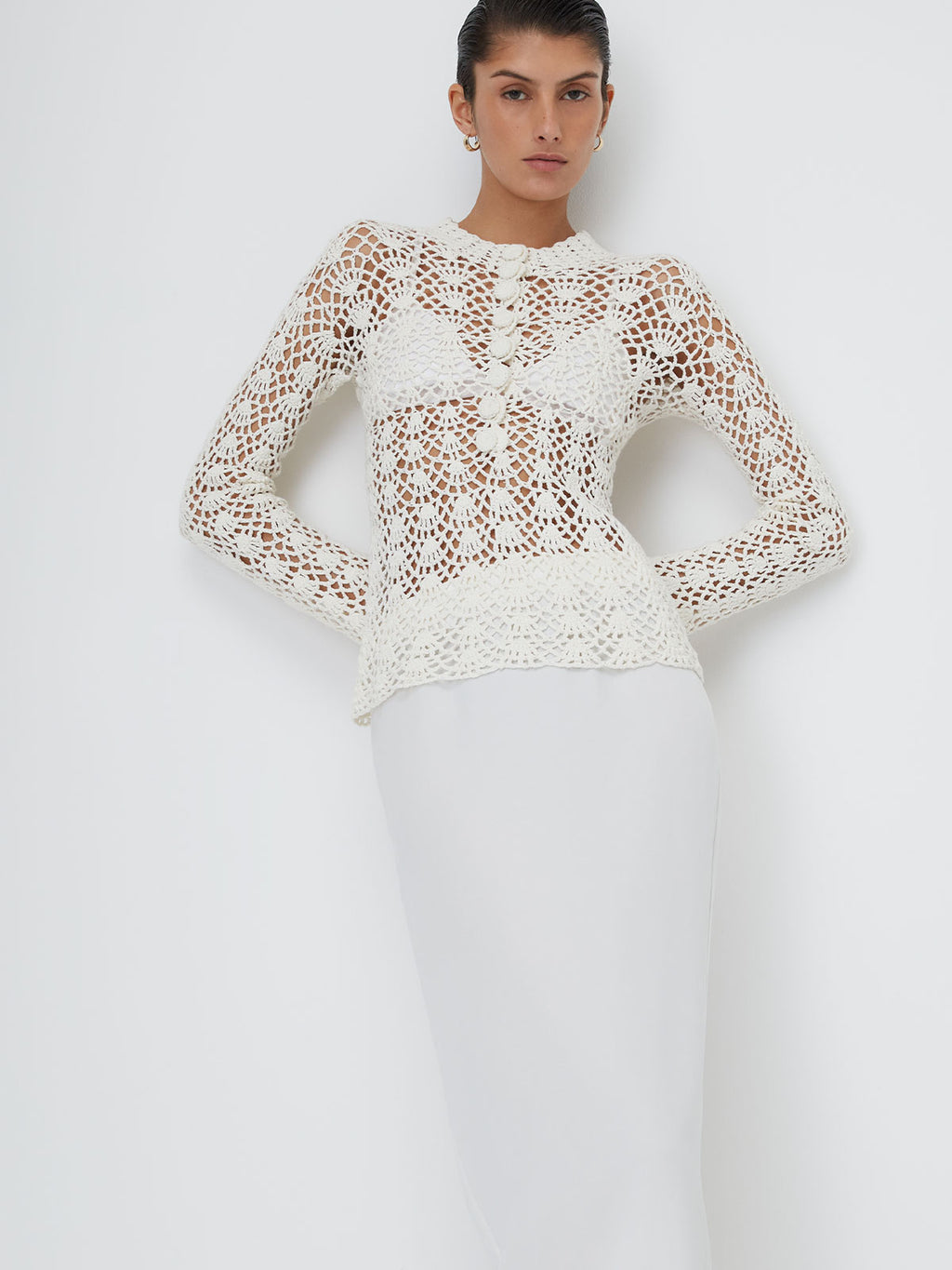 Model wearing the White 9 Crochet Top on top of a white background