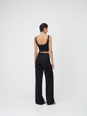 Back view of a model wearing a Black Marnie Top and dark trousers