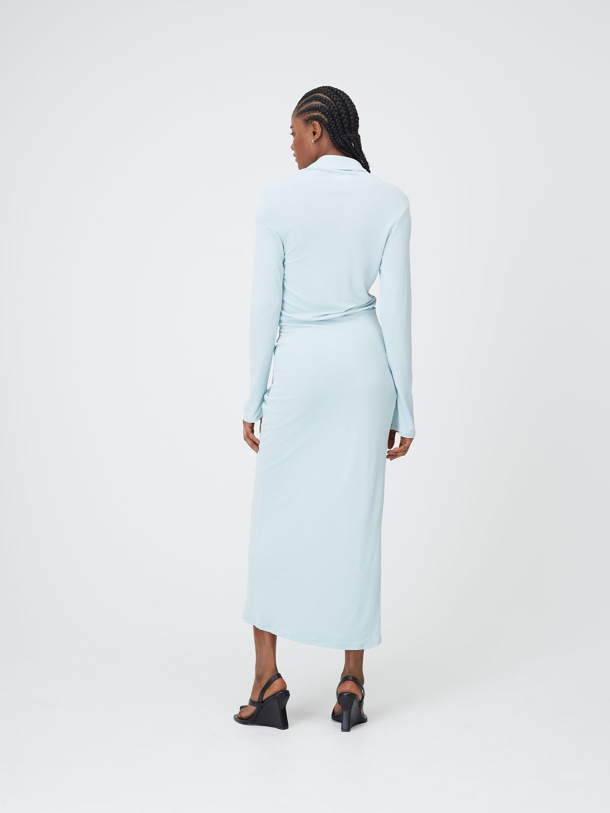 Back view of a female figure wearing the Mineral Blue 09 Slinky Shirt Dress on top of a white background