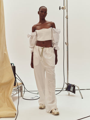 Model in a studio wearing White Ruffle Bodice