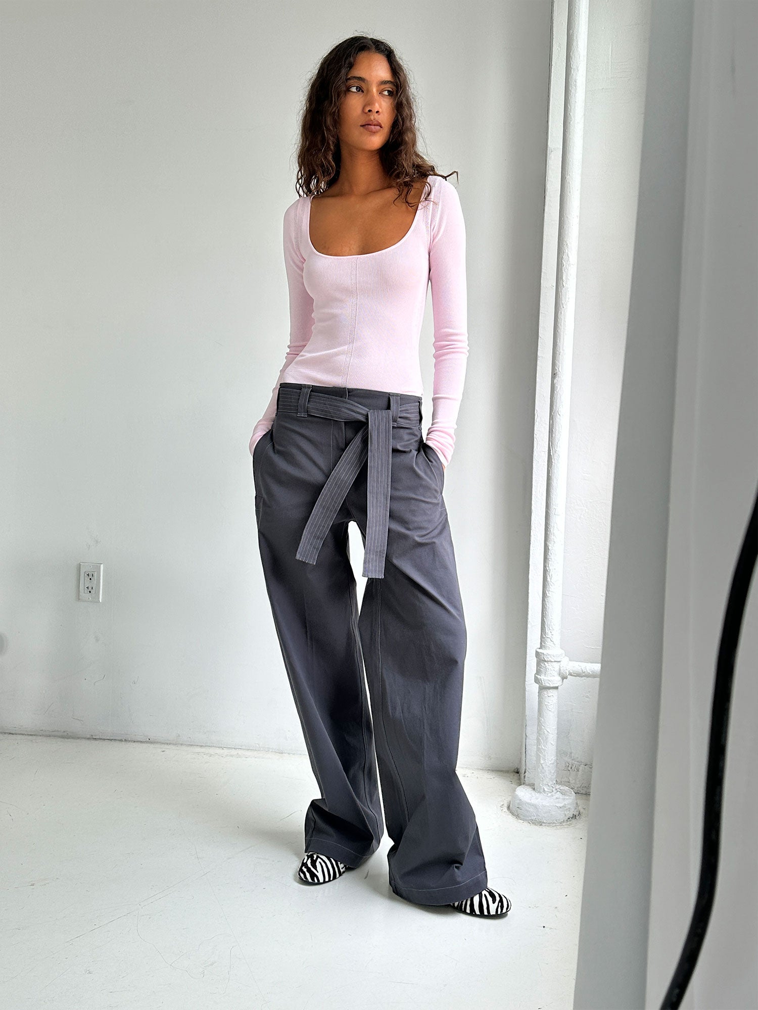 Model wearing a Pale Pink Elemental Second Skin Top and concrete trousers