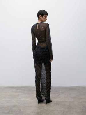 Back view of a model wearing a Black and Gold 09 Galaxy Skirt and 09 Galaxy Top