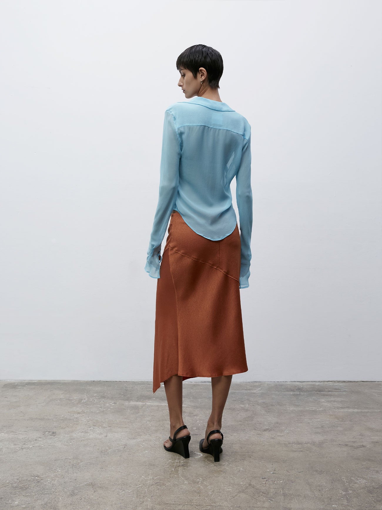 Back view of a model wearing the Iris Blue 09 Sheer Silk Shirt 