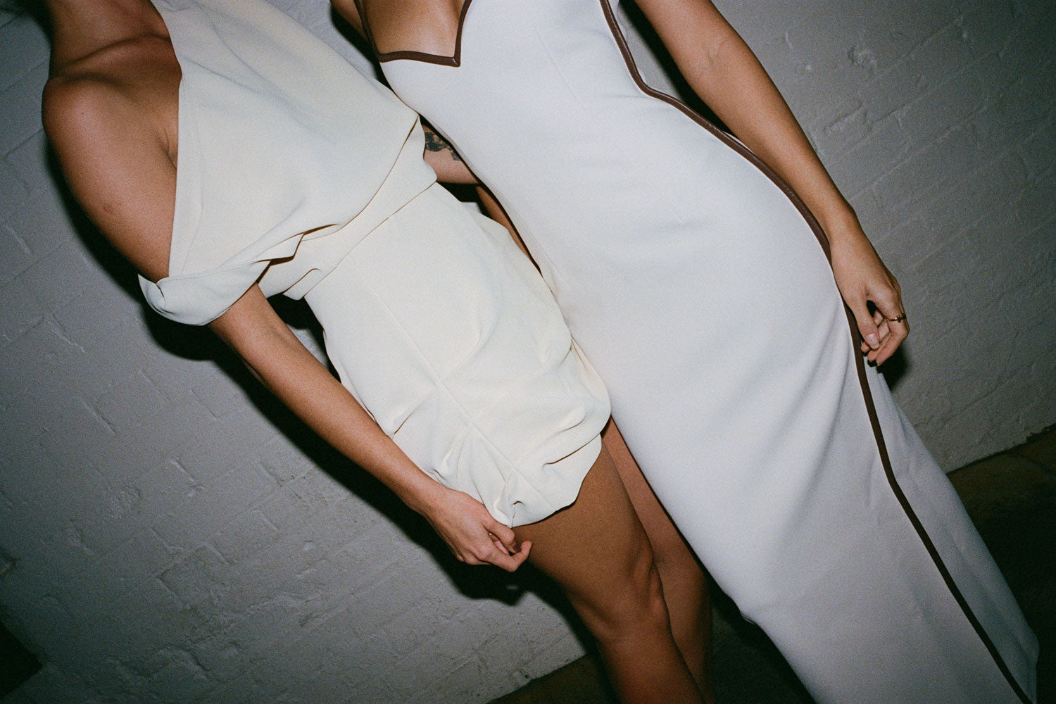 Close up view of two female figures wearing the Butter 09 Remmy Mini Dress and Cream & Carob 09 Heart Dress