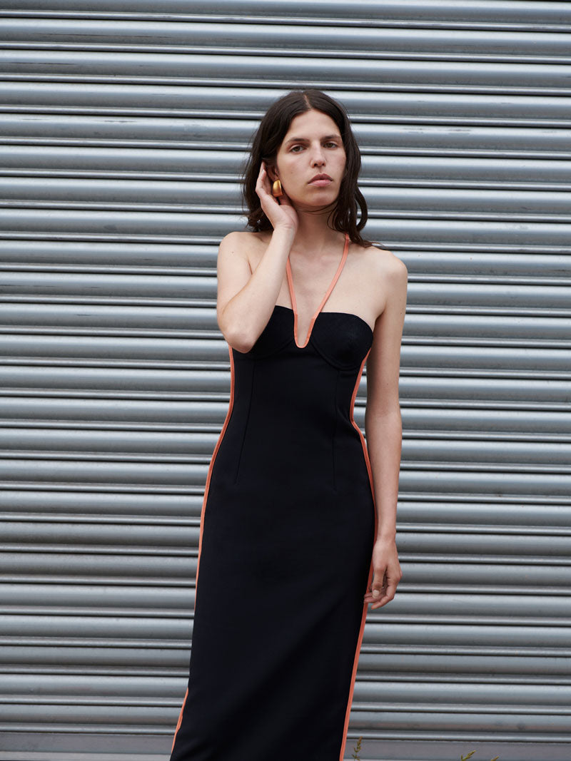 A model wearing the Black & Coral 06 Nassia Dress