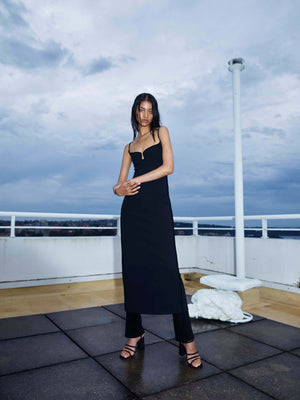 Model on balcony wearing Marlo Dress in black 